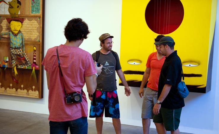 Brazillian twins Os Gemeos in front of two of their pieces (photo © Geoff Hargadon)