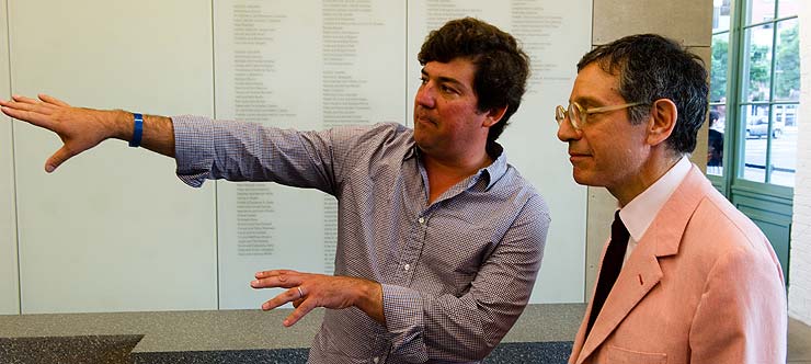Curator Pedro Alonzo show's Jeffrey Dietch the indoor exhibition of the newly opened show. (© Geoff Hargadon)