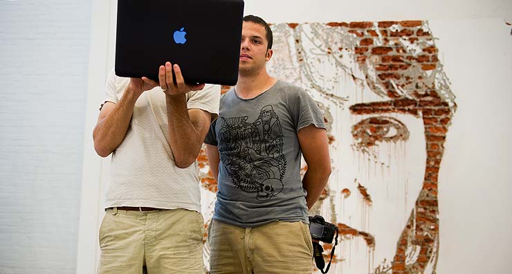 French Street Artist JR and his assistan Youssef doing a bit of Skyping before the show (© Geoff Hargadon)