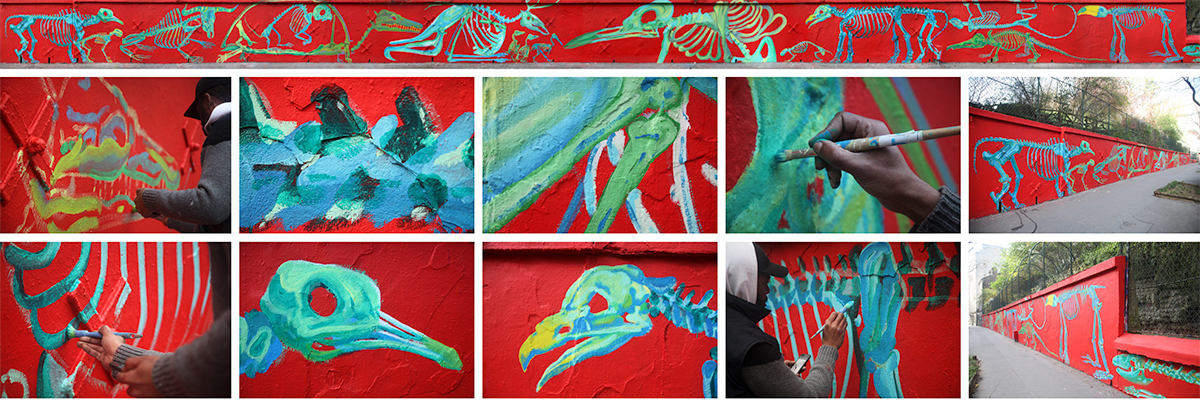 Gris Fluo Glows With Skeletal Characters on a Red Parisian Wall