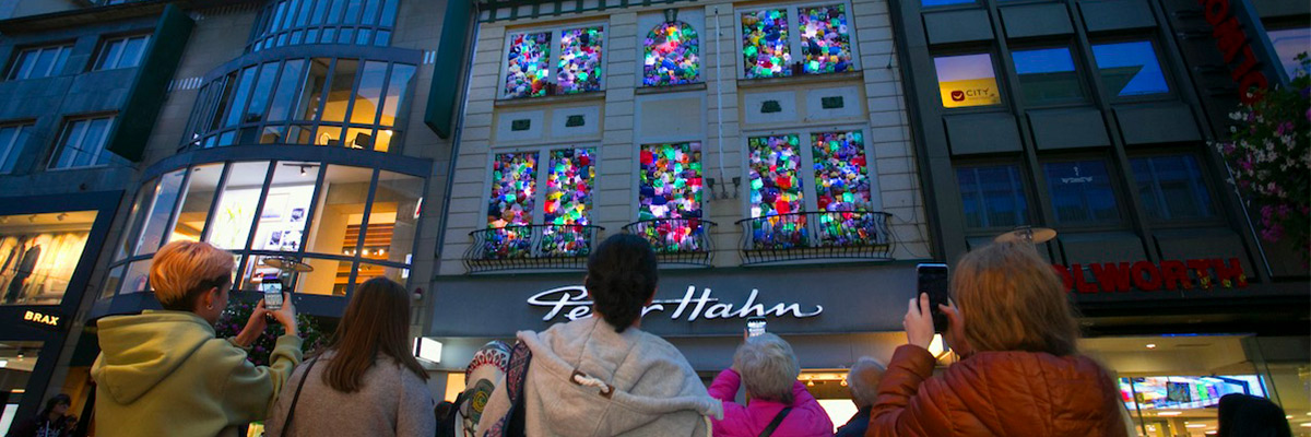 Luzinterruptus: “The Plastic We Live With” Looks Like Painted Glass in a German Facade